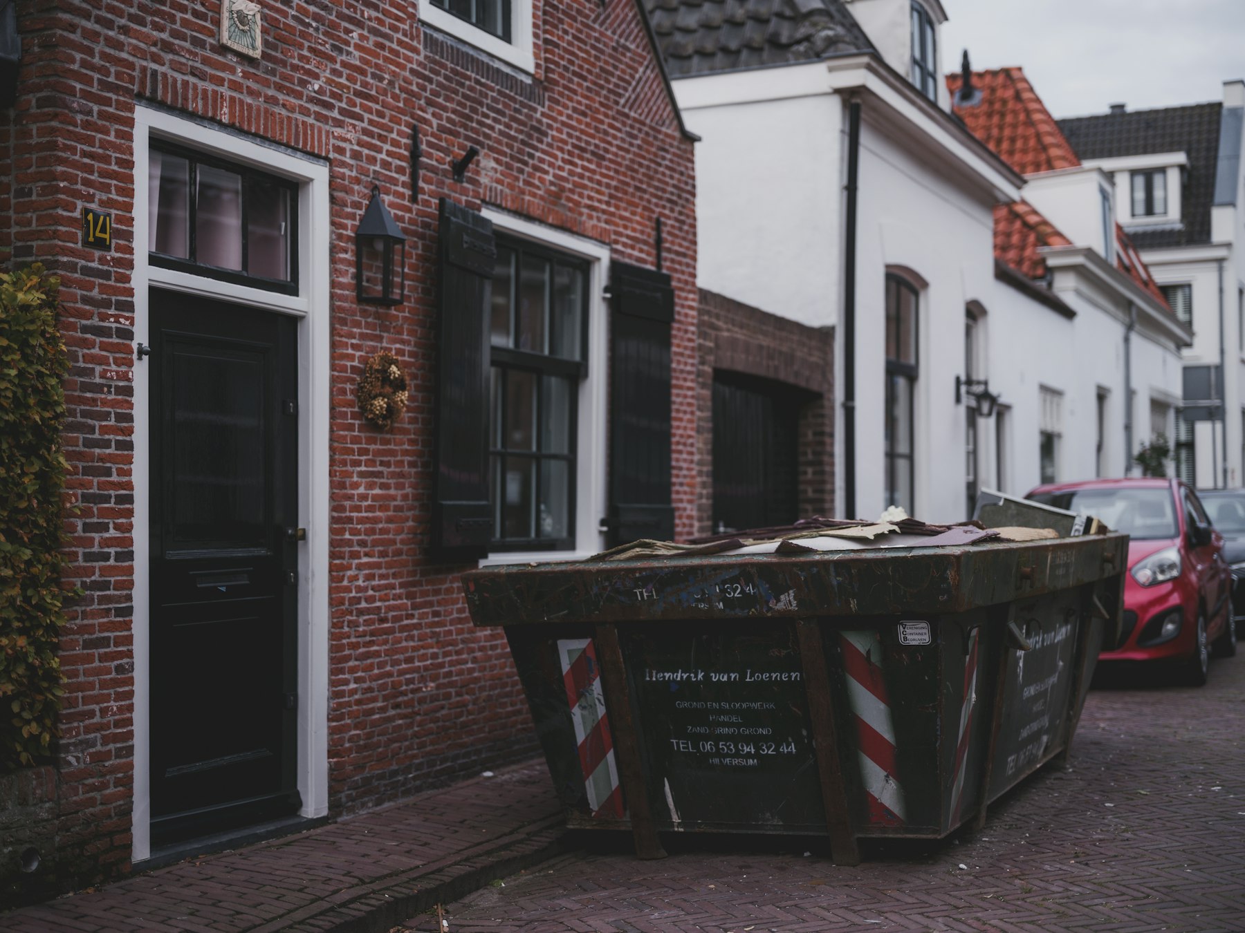 Large skip container placed on a residential street for renovation waste removal
